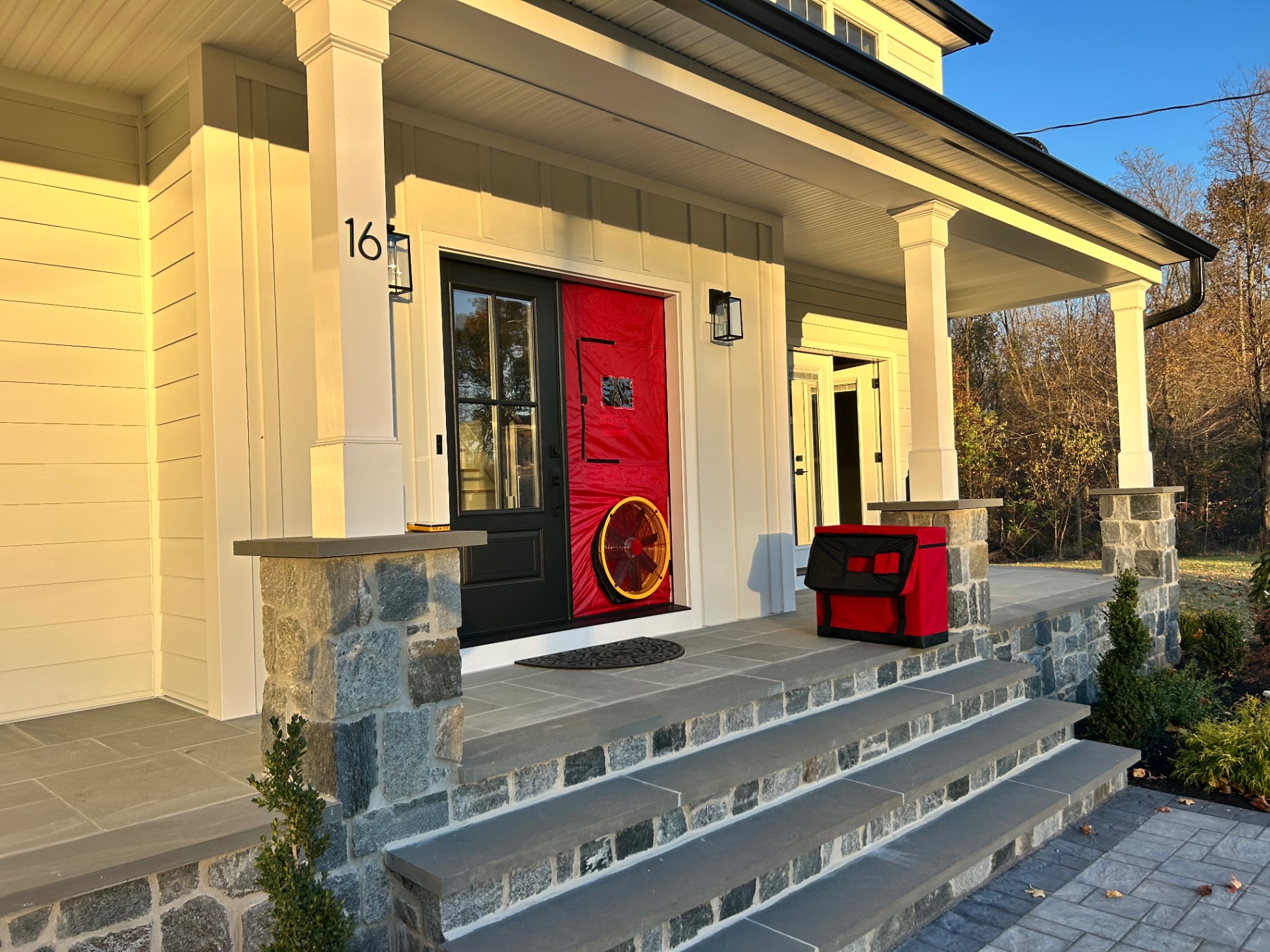Blower door test equipment installed on home front door